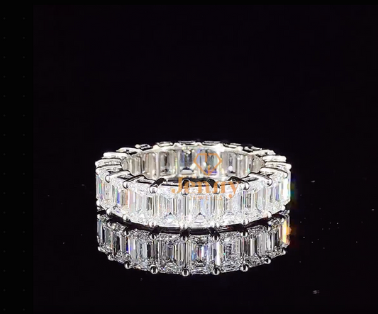 Full eternity band with vibrant emerald gemstones, set in white, yellow, or rose gold. A timeless and elegant stacking ring for any occasion.